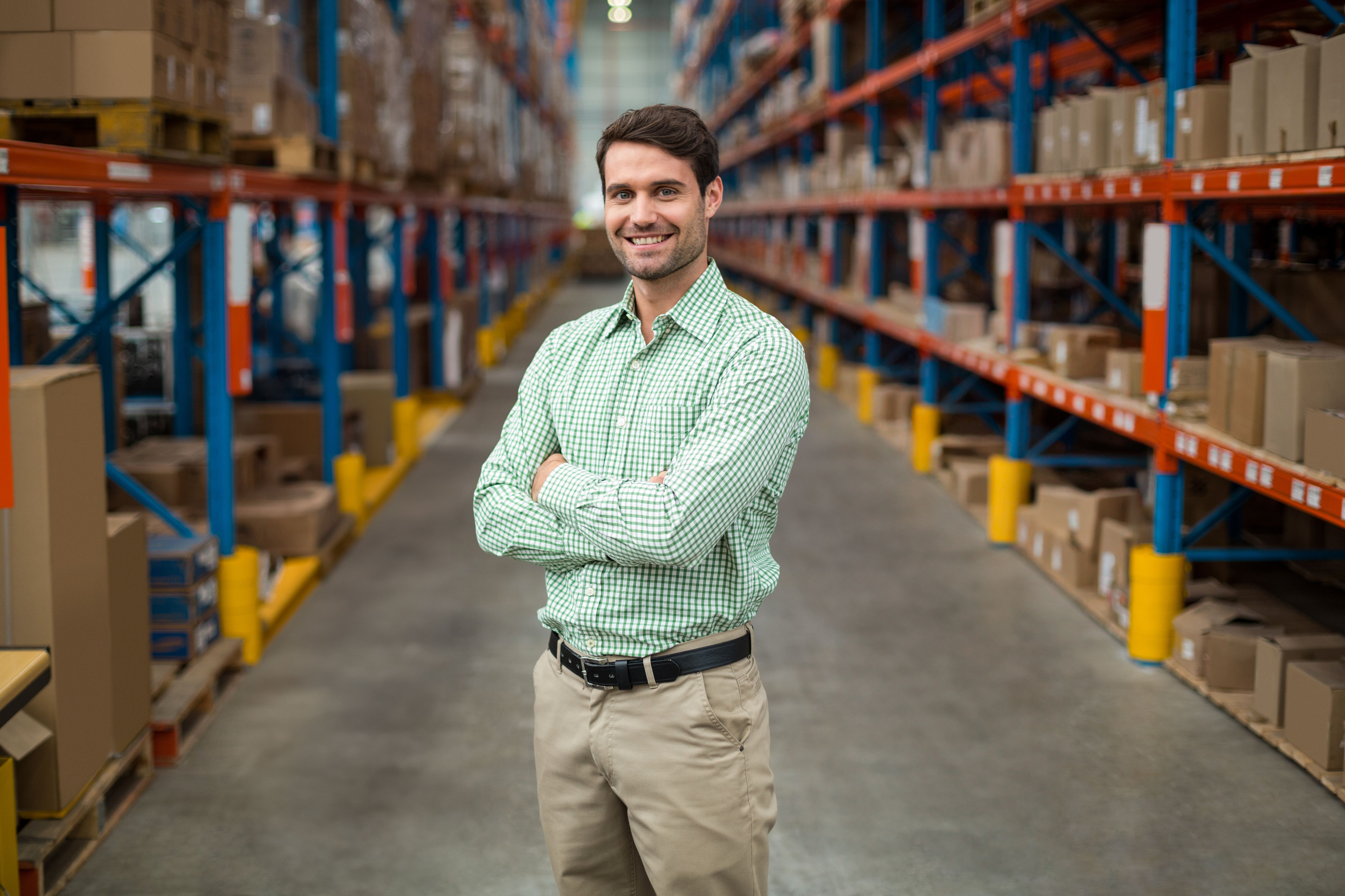 standing-man-crossing-arms-in-warehouse-aisle-wit-2026-01-08-23-34-44-utc